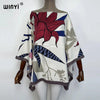 A women's bohemian summer batwing abaya top featuring a floral print in shades of red, blue, and beige.