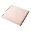 A square, light pink foldable Islamic prayer rug with embossed decorative patterns.
