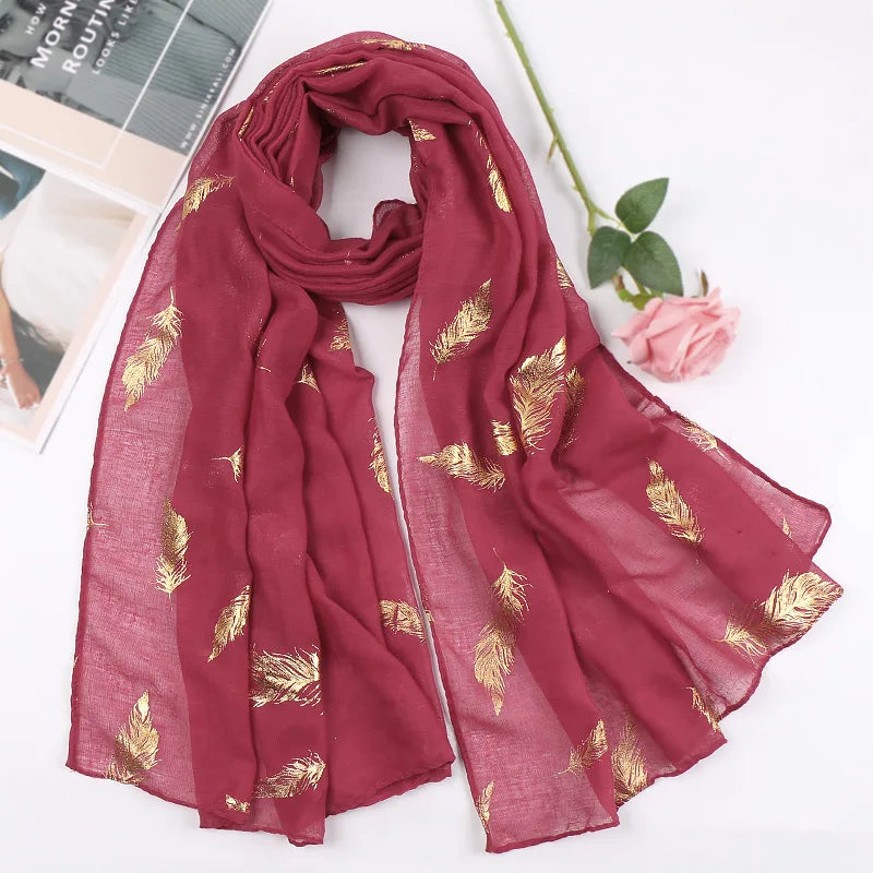Tiefmaroniges Chiffon-Schal mit goldfarbener Feder-Muster, elegant drapiert.