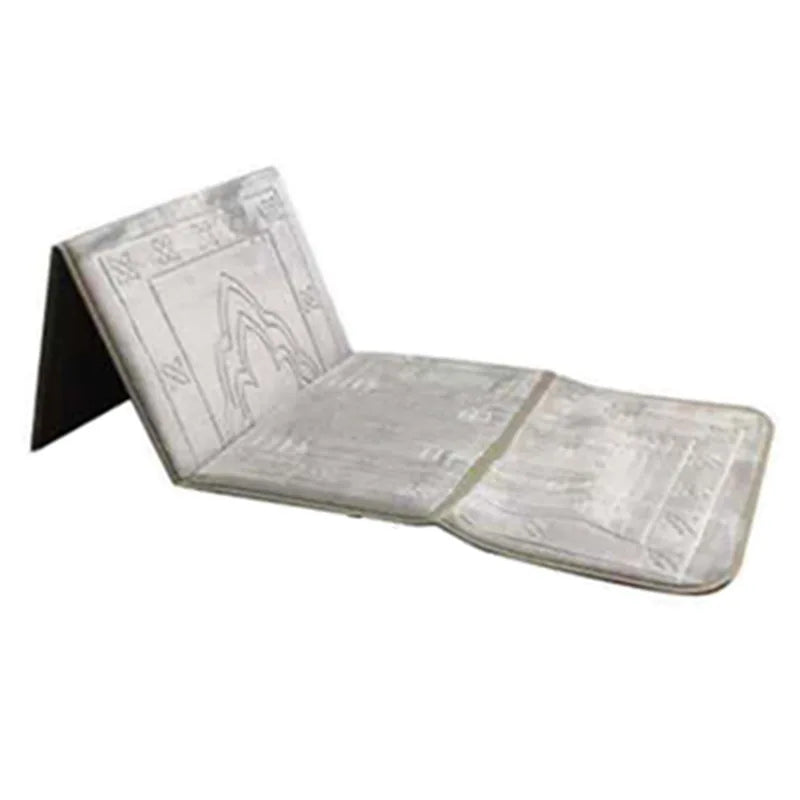 A foldable Islamic prayer rug in a light gray color, shown folded and unfolded.