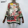 A women's bohemian summer batwing abaya top featuring a colorful floral and leaf print in earthy tones.