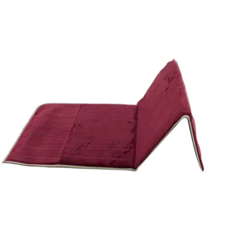 A folded maroon Islamic prayer rug displayed flat.
