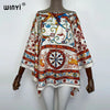 A woman wearing a colorful bohemian summer batwing abaya top with intricate patterns.