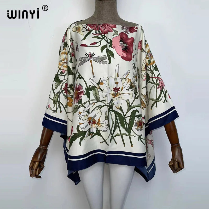 A women's bohemian summer batwing abaya top featuring a floral print on a beige fabric.