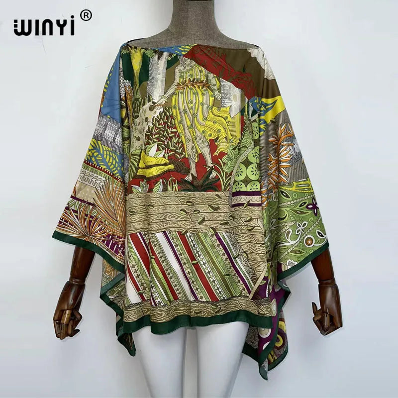 A model is wearing a colorful bohemian summer batwing abaya top featuring intricate patterns and earthy tones.