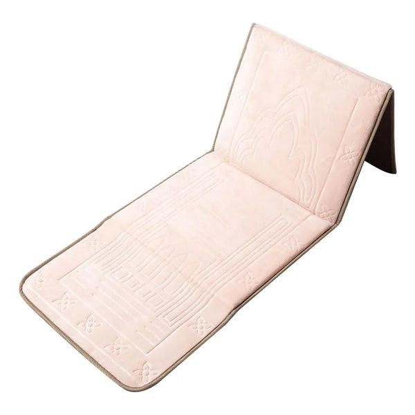 A folded pink Islamic prayer rug with quilted texture and decorative stitching.