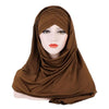 Un modèle portant un foulard en jersey de coton brun drapé sur sa tête et ses épaules.
