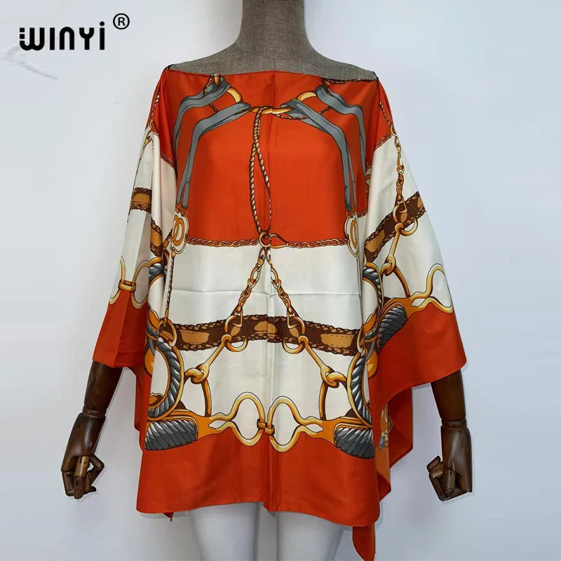 Orange and cream batwing abaya top featuring intricate gold and silver chain detailing