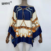 A women's blue and cream batwing abaya top featuring intricate gold chain detailing.