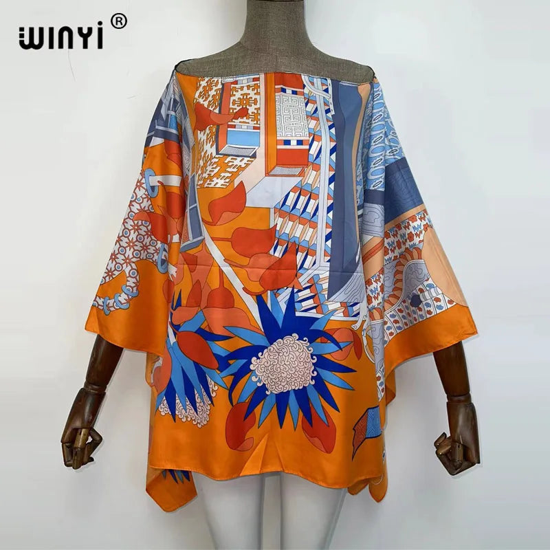 Orange and blue patterned batwing abaya top displayed on a mannequin