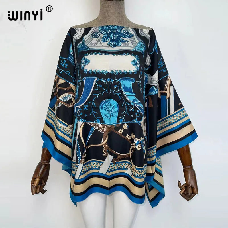 A black and blue patterned batwing abaya top displayed on a mannequin.