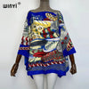 A woman models a blue and multicolored bohemian summer batwing abaya top with intricate patterns.