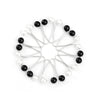 A circular arrangement of twelve silver-toned pins with pearl-like beads, used for headscarf or hair accessories.