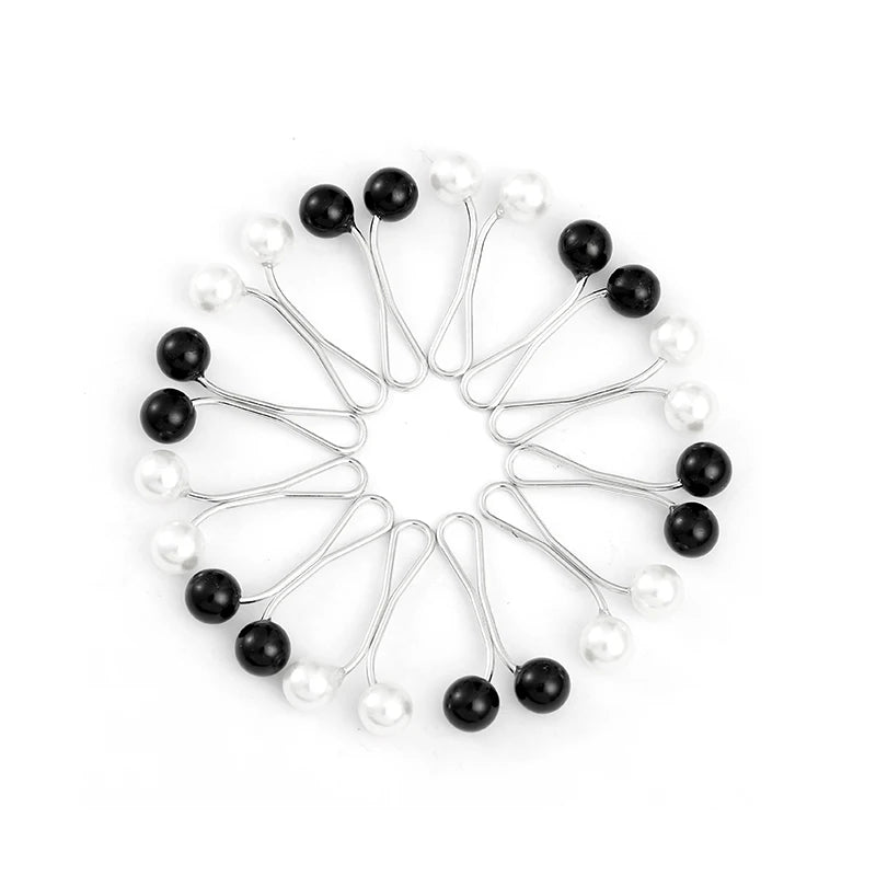 A circular arrangement of twelve silver-toned pins with pearl-like beads, used for headscarf or hair accessories.