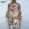 A women's bohemian summer batwing abaya top featuring floral and paisley patterns in soft pink, green, and red tones.
