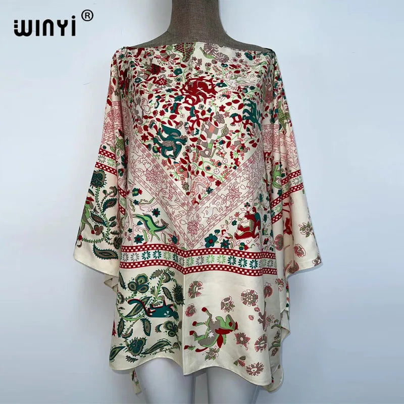 A women's bohemian summer batwing abaya top featuring floral and paisley patterns in soft pink, green, and red tones.