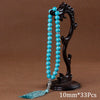 Black agate prayer beads on a stand with a turquoise tassel necklace