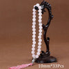 Black agate prayer beads on a stand with a pink tassel necklace