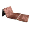 A folded brown Islamic prayer rug with intricate patterns.