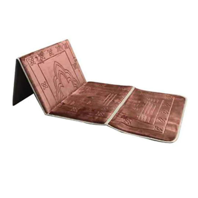 A folded brown Islamic prayer rug with intricate patterns.