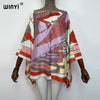 A women's bohemian summer batwing abaya top featuring a colorful, patterned fabric with pink, orange, and purple tones.