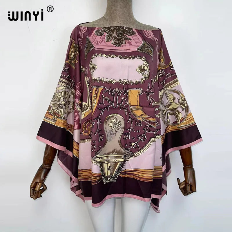 A women's bohemian summer batwing abaya top in shades of purple, pink, and brown with intricate embroidery.