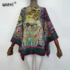 A women's bohemian summer batwing abaya top featuring intricate floral and animal patterns in shades of green, pink, and yell