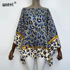 A women's bohemian summer batwing abaya top featuring a blue and gold leopard print on white fabric.