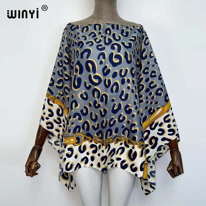 A women's bohemian summer batwing abaya top featuring a blue and gold leopard print on white fabric.