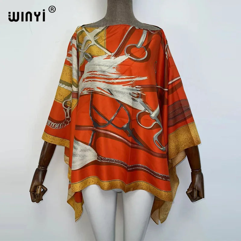 Orange and beige batwing abaya top featuring white and gold tribal patterns
