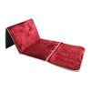 A folded red velvet Islamic prayer rug displayed flat.