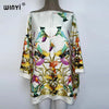 White batwing abaya top featuring a vibrant floral pattern with colorful birds and foliage.