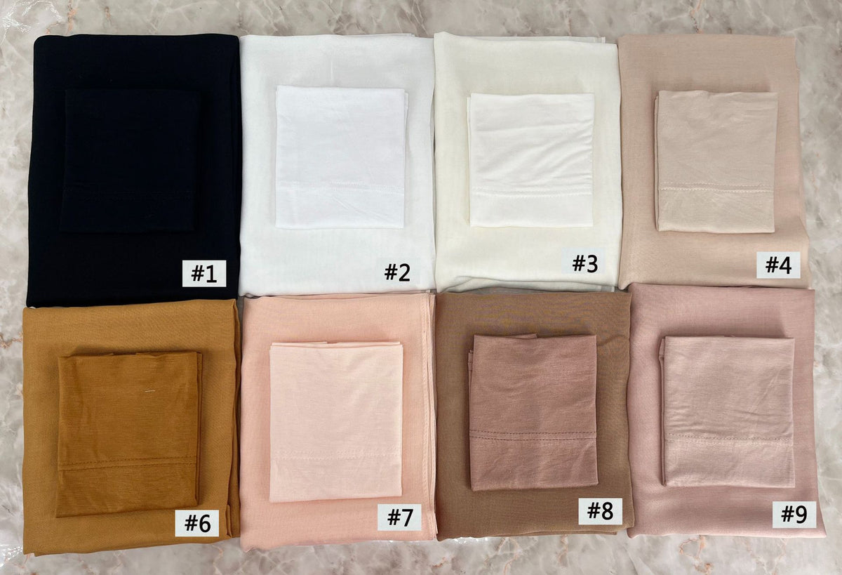 A set of nine folded soft modal rayon hijab fabric squares in various neutral tones including black, white, beige, and pink.