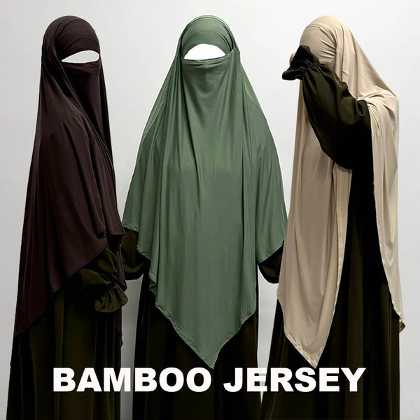 Three women wearing flowing bamboo jersey khimars in shades of brown, green, and beige.