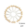 A set of 12 gold pearl brooch headscarf pins arranged in a circular pattern.