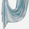 A light blue printed linen hijab scarf draped elegantly.
