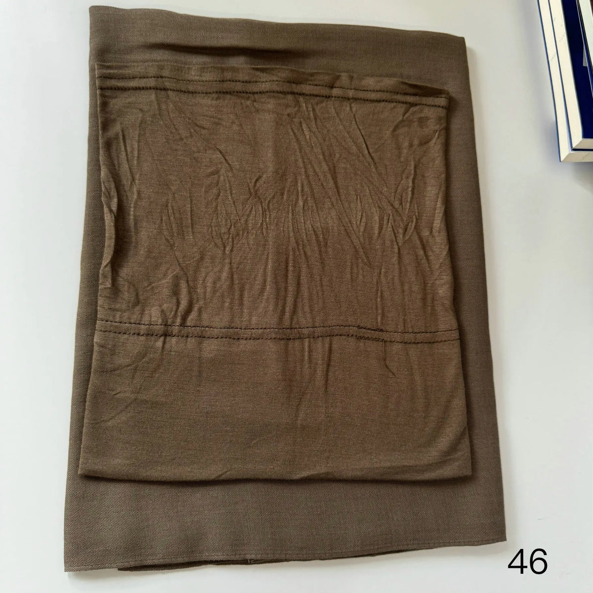 A folded olive brown soft modal rayon hijab set for women.