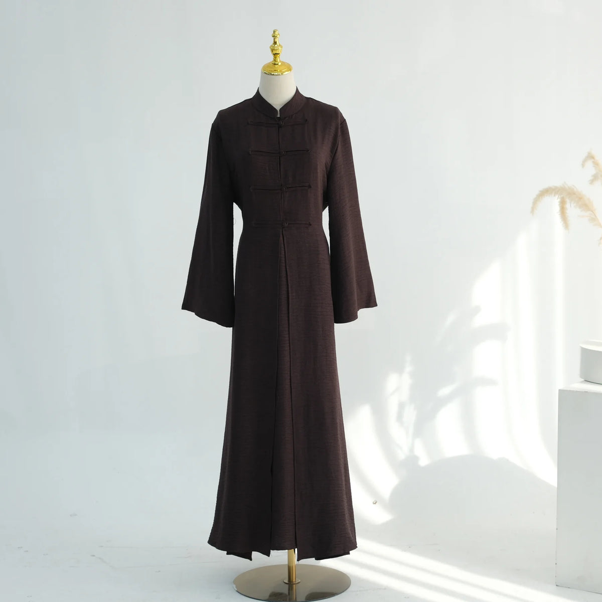 A dark brown elegant two-piece Arabic modest set displayed on a mannequin.