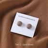 Set of 2 khaki macaron brooches for hijab clips displayed on a brown fabric.