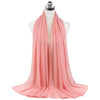 A soft coral pink chiffon hijab scarf draped around a mannequin's neck.