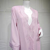 Vestido kaftan largo rosa con intrincados detalles de encaje de ganchillo en cuello y puños.