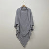 A light gray two-layer everyday hijab scarf draped on a wooden hanger against a plain wall.
