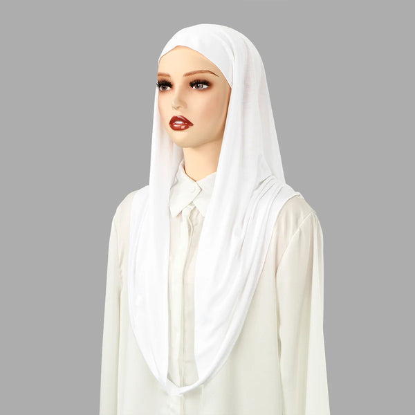 A woman wearing a white instant ready-to-wear jersey hijab scarf and matching top.