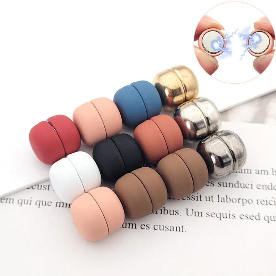A set of two macaron-shaped brooches in various colors, including pink, brown, black, and gold, displayed on a white backgrou