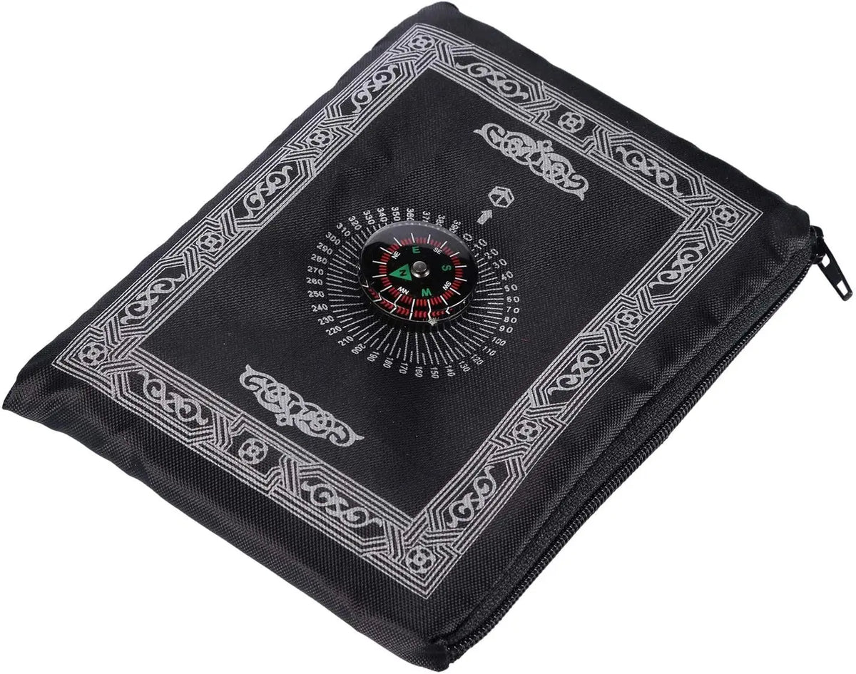 Black portable braided prayer rug featuring an ornate compass design on the surface.