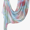 A flowing, sheer linen hijab scarf featuring a watercolor print of pink and green floral patterns.