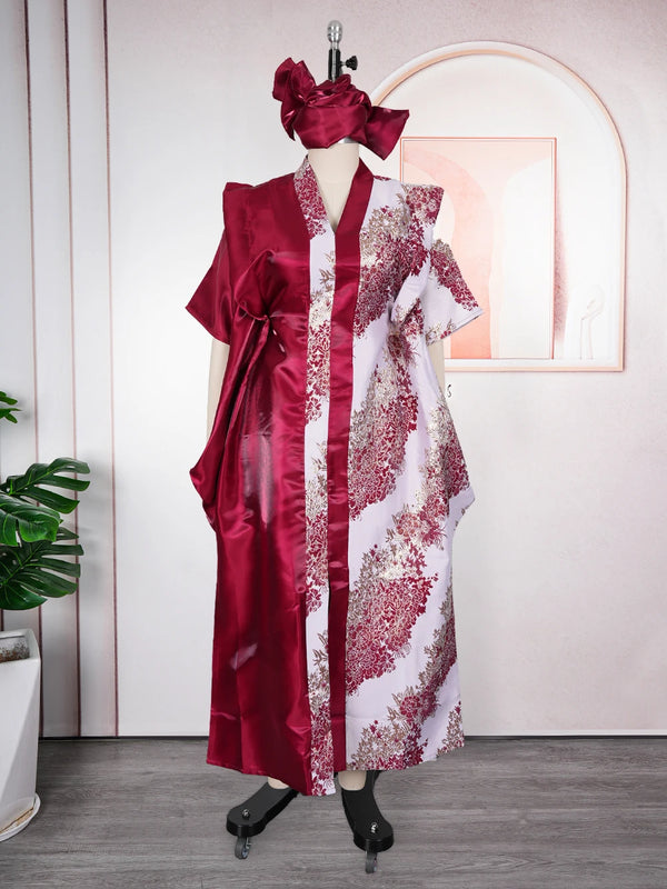 A woman wearing an elegant flowing kaftan dress in deep red and white with floral tatting detail.