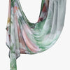 A flowing, sheer linen hijab scarf featuring an elegant watercolor print of green and pink foliage.