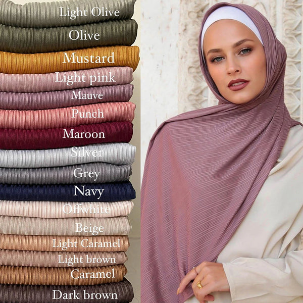 A close-up of a woman wearing a mauve thread cotton jersey hijab scarf in a soft pink tone.