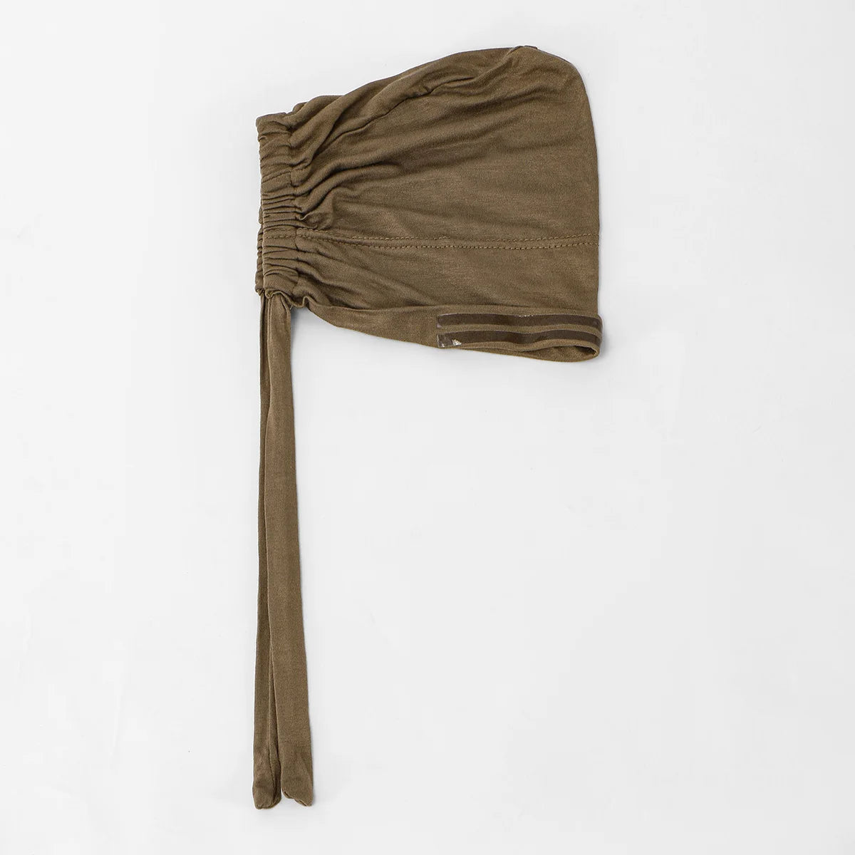A brown, pleated anti-slip inner hijab cap with a long strap is shown against a white background.